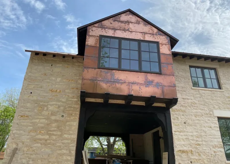 Copper metal panel facade on a stone building for Roof Repair in North Richland Hills